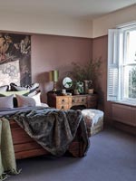 Modern country bedroom with dusky pink painted walls 