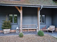 Country house exterior - Christmas tree on covered porch 