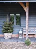 Country house exterior - Christmas tree on covered porch 