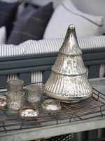 Detail of silver Christmas decorations and tealight holders 