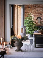 View to Christmas tree against exposed brick wall 