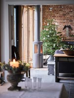 View to Christmas tree against exposed brick wall 