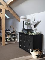 Black chest of drawers in modern bedroom 