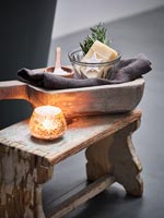 Bathroom accessories with candle on small wooden stool 