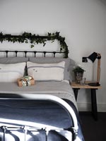 Christmas garland and gift in country bedroom 