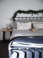 Christmas garland and gift in country bedroom 