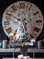 Large clock, Christmas decorations and candles on wooden table 