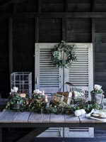 Exterior wooden table on covered terrace decorated for Christmas 