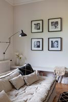 Display of black and white photographs on living room wall 