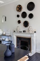 Display of baskets on wall above fireplace 