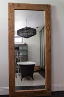 Reflection of modern bathroom in large mirror 