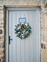 Christmas wreath on country house front door 