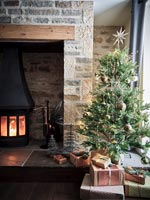Christmas tree next to fireplace 