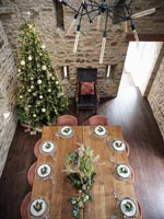 Overhead view of wooden dining table laid for Christmas dinner 