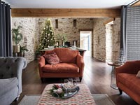 Country open plan living and dining space decorated for Christmas 