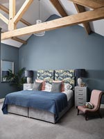 Modern bedroom with exposed wooden beams 