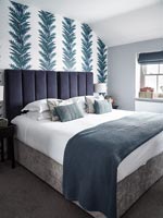 Modern bedroom with patterned wallpapered feature wall 