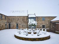 Exterior of country house and garden in snow 