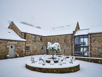Exterior of country house and garden in snow 