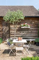 Small cafe style table and chairs in country garden 