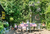 Outdoor dining table in cottage garden 