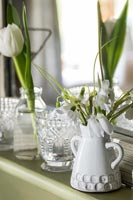 White cut flowers in white ceramic vases 
