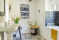 Vintage shop signage on wall in modern country bathroom 