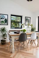 Modern dining table and chairs with black framed window 