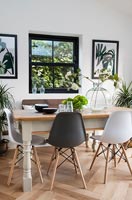 Modern dining table and chairs with black framed window 