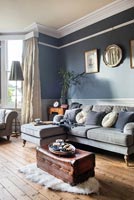 Dark grey painted walls and original features in modern living room 