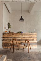 Modern kitchen counter and bar stools made from reclaimed wood 