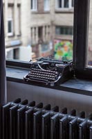 Vintage typewriter on windowsill 