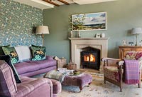 Purple sofa in green country living room 