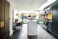 White marble island in centre of modern kitchen 