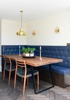 Corner banquette seating around table in modern kitchen-diner 