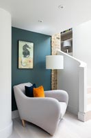 Modern armchair in snug at bottom of stairs 