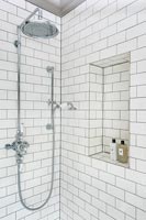 White brick style tiling in modern shower cubicle 
