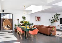 Colourful dining room with large sofa 