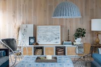 Living room with wood plank walls and blue themed decoration 