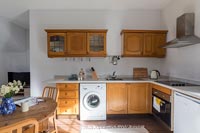 Recycled kitchen with old wooden cabinets and simple furniture