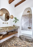 Modern country bathroom with textured pebble floor 