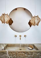 Mirror and pendant lights over marble sink - closeup