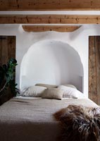 Modern country bedroom alcove around head of bed 