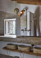 Large stone sink and mirror in modern country bathroom 