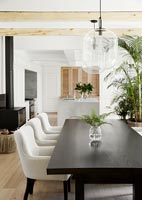 Modern black dining table with cream upholstered chairs 