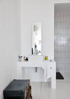 White tiled shower area and modern sink