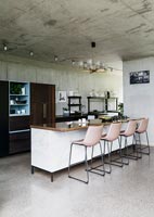 Contemporary dining area with concrete walls