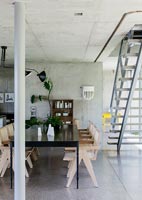 Modern dining area with bare concrete walls