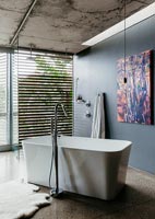 Modern ensuite bathroom with contemporary artwork on wall
