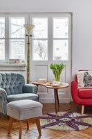 Living room with an eclectic mix of old and new furniture 